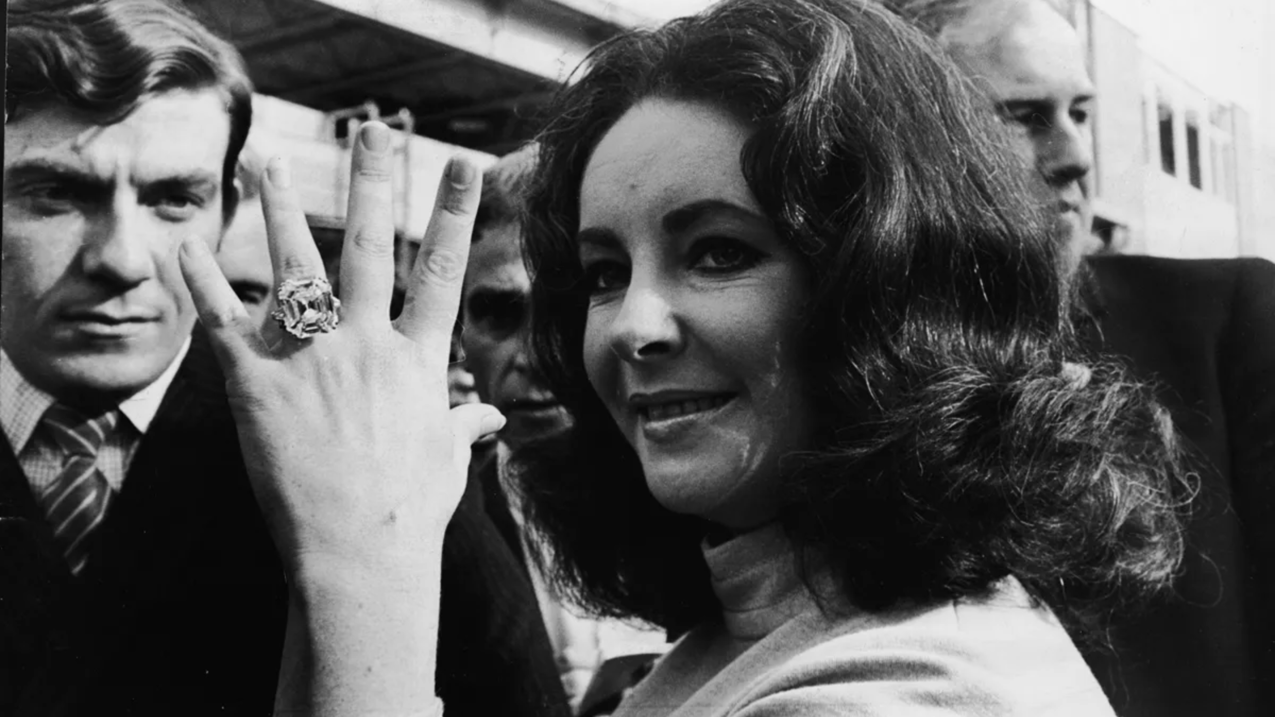 Elizabeth Taylor shows off the diamond ring given to her by her husband, Richard Burton